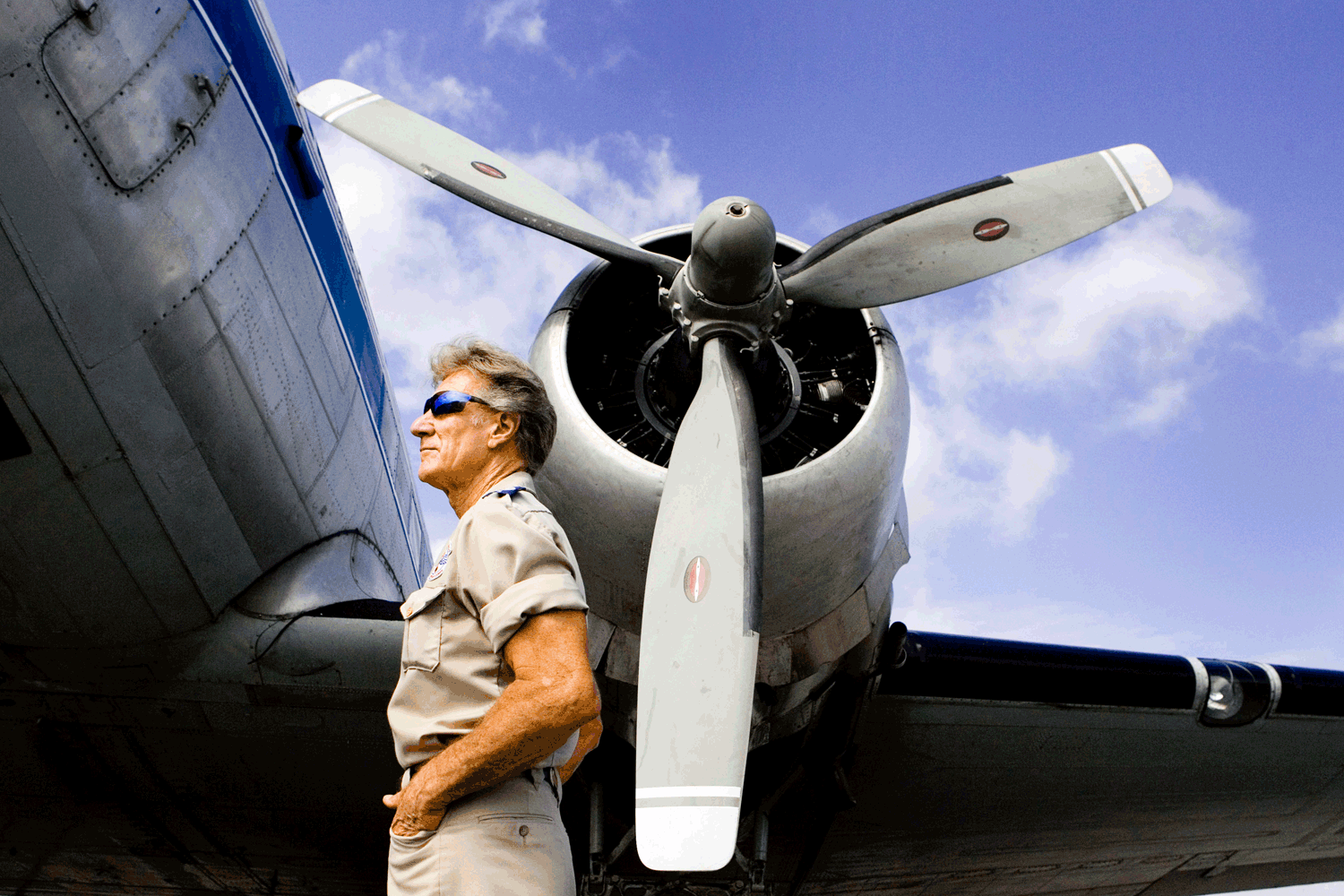 Stan Brock, the founder of Remote Area Medical, stands in front of a World War II cargo plane in Wise, Virginia. Photo by Suzy Allman