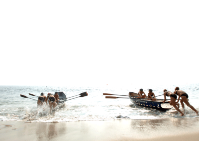 Women shove life saving boats into the surf during the All-Women Lifeguard Tournament in Sandy Hook, New Jersey.