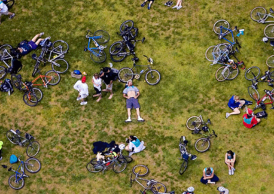 Riders in the Five Boro Bike Tour rest after participating in the Five Boro Bike Tour in New York City.