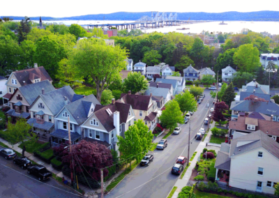 An overhead, aerial picture of a neighborhood in Tarrytown, showing proximity to the New Tappan Zee Bridge, the Hudson River, and the shore beyond.