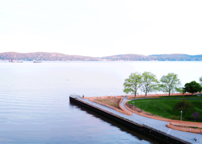 Overhead view using drone of Pierson Park in Tarrytown, New York, with Nyack, the Palisades and the Hudson River in the background in early morning