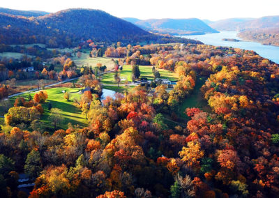 An aerial drone photograph of the colorful Hudson Valley landscape at daybreak, taken from Garrison, New York and looking south toward the Hudson River.
